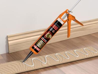 Applying EVO-STIK Seriously Strong Stuff Fast Setting Adhesive in a zigzag pattern to a wooden board before fixing a skirting board