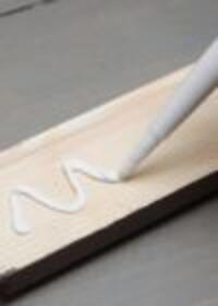 Applying grab adhesive to a timber board